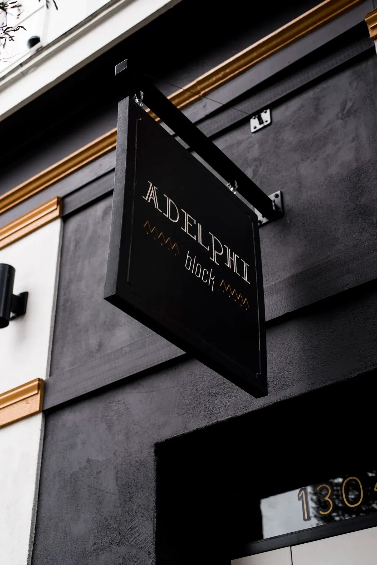 The Adelphi Block sign hanging over the pavement