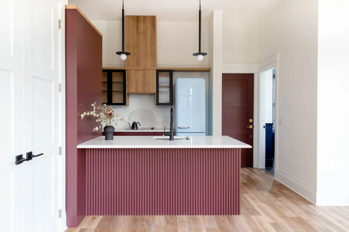 Maroon island, wood cabinetry, white counters