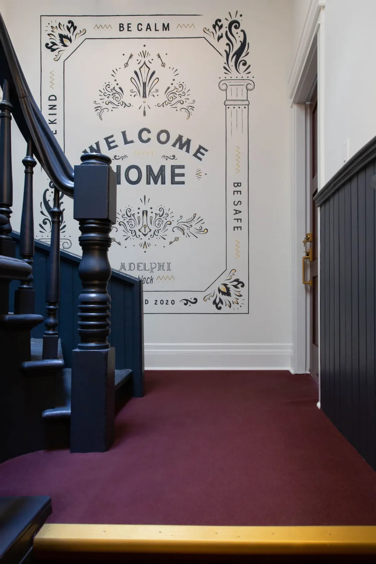 The dark wood stair and the Welcome Home sign