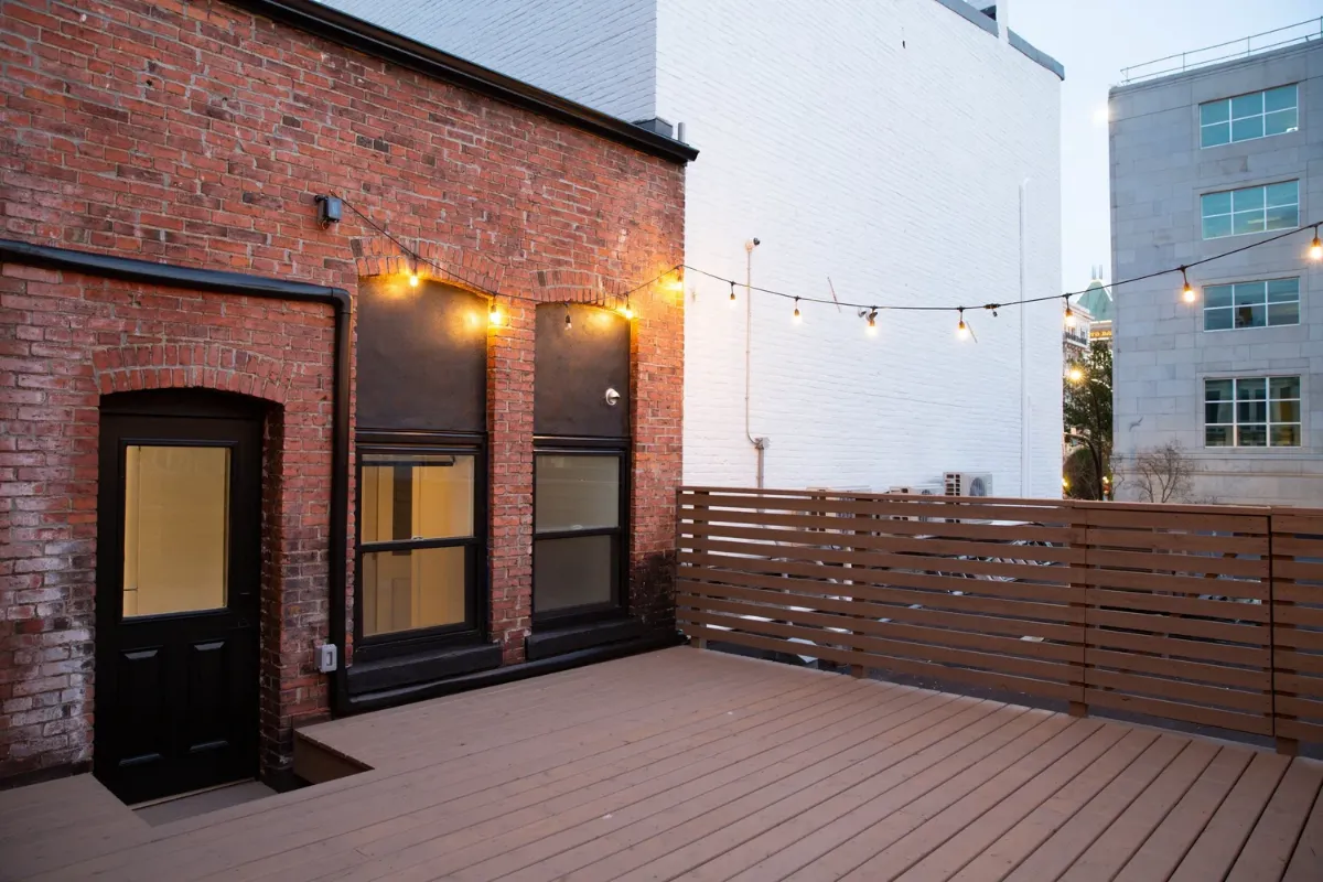 The rooftop deck under its string lights