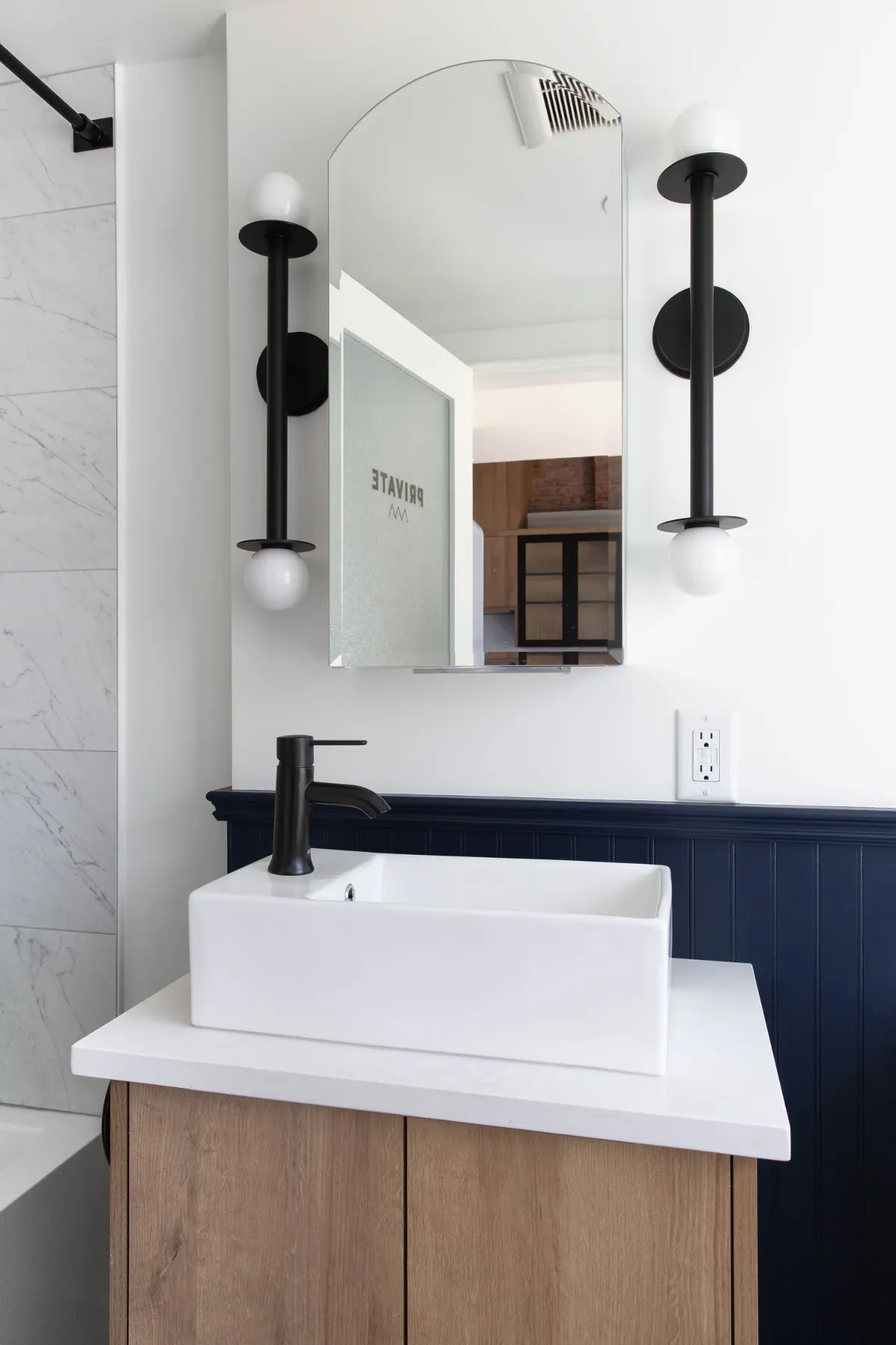 The vanity, vessel sink and twin globe lights