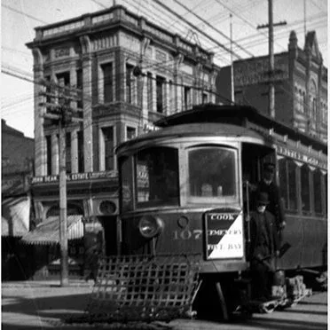 A streetcar on Government Street, passing the building