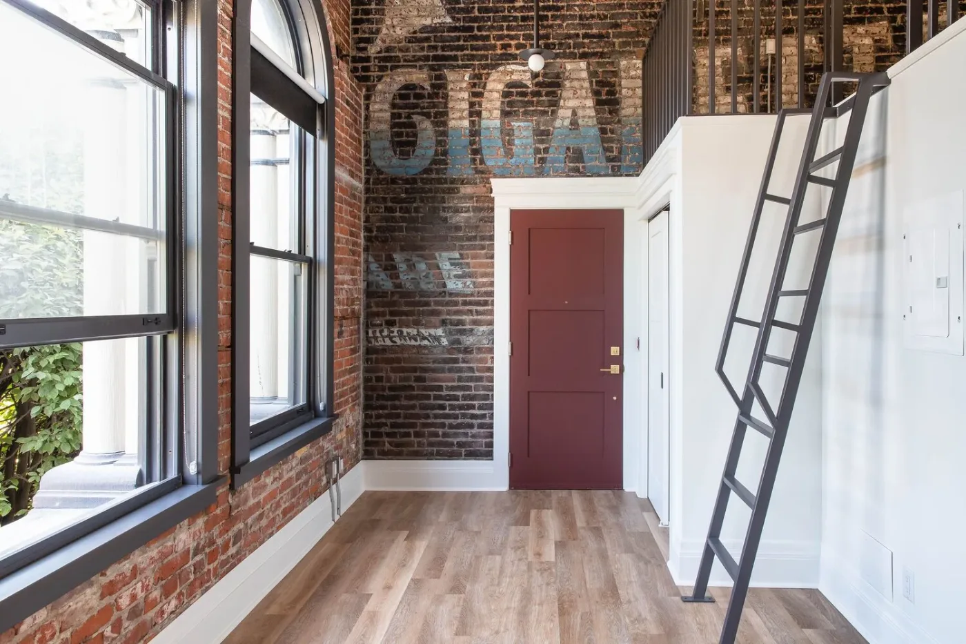 The loft at 202, a black ladder against the original brick