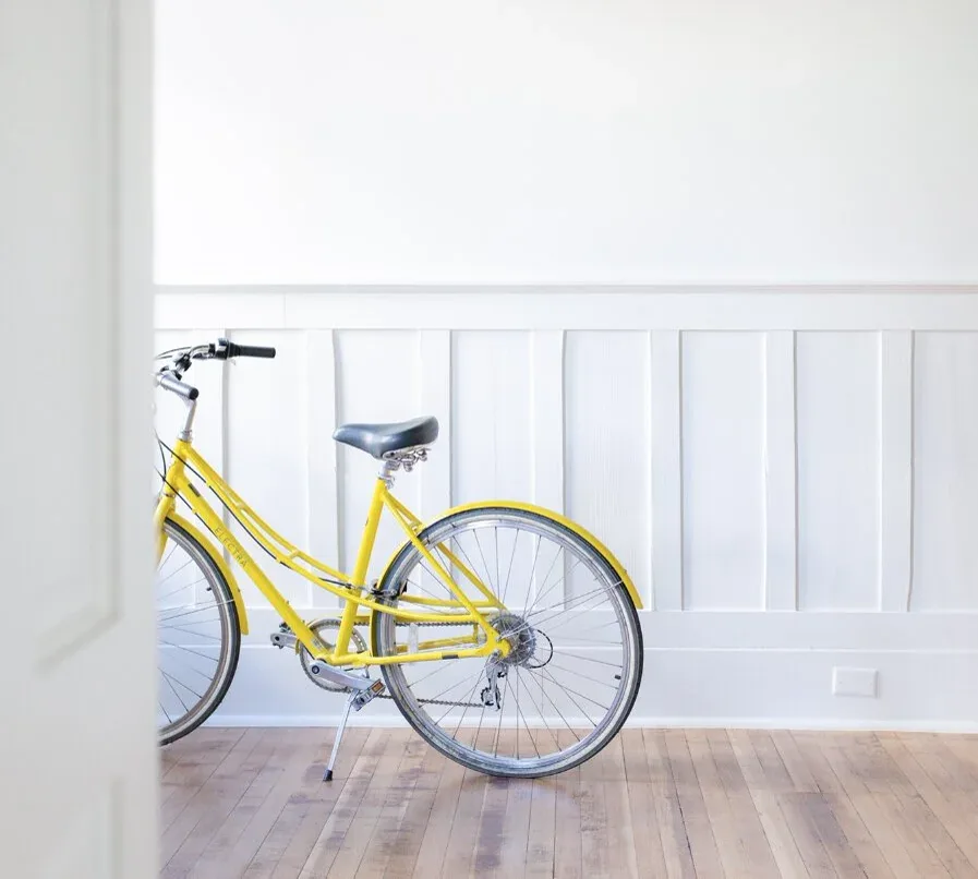 A bicycle against the wainscotting in a Bell Apartments home