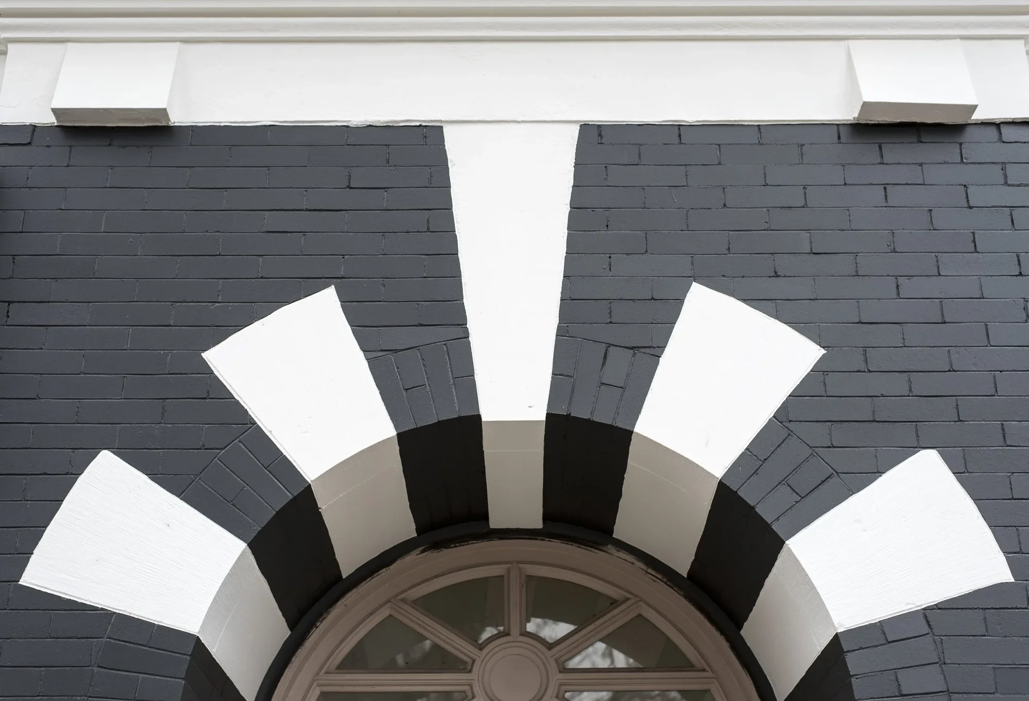 Painted brick arch over the entrance at Bell Apartments