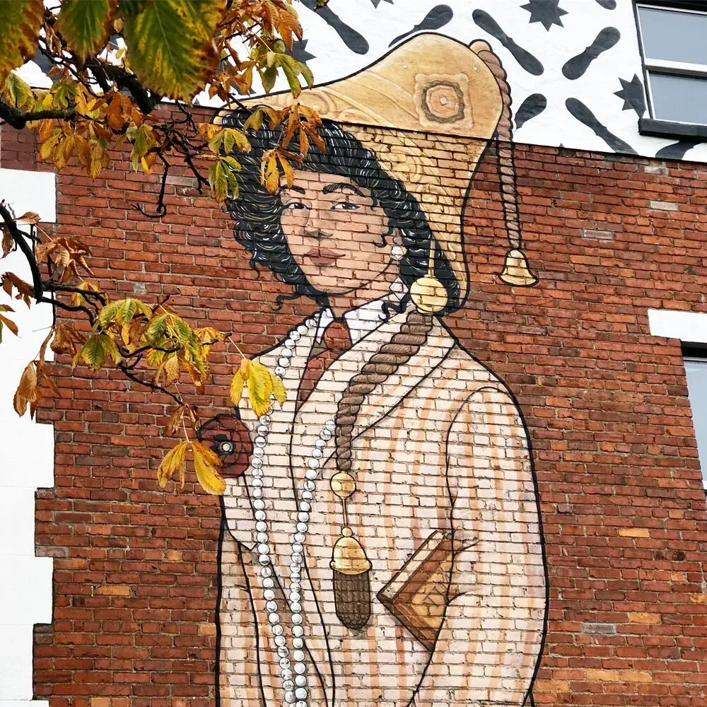 The Suffragette figure painted on the brick south facade
