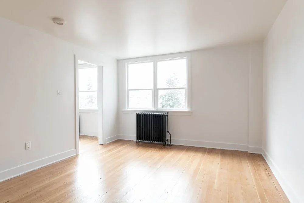 An empty room on the Kennedy floor, window and radiator