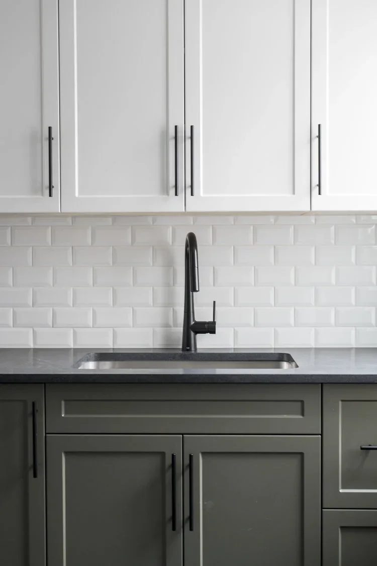 The sink and olive cabinetry in a Kennedy floor kitchen