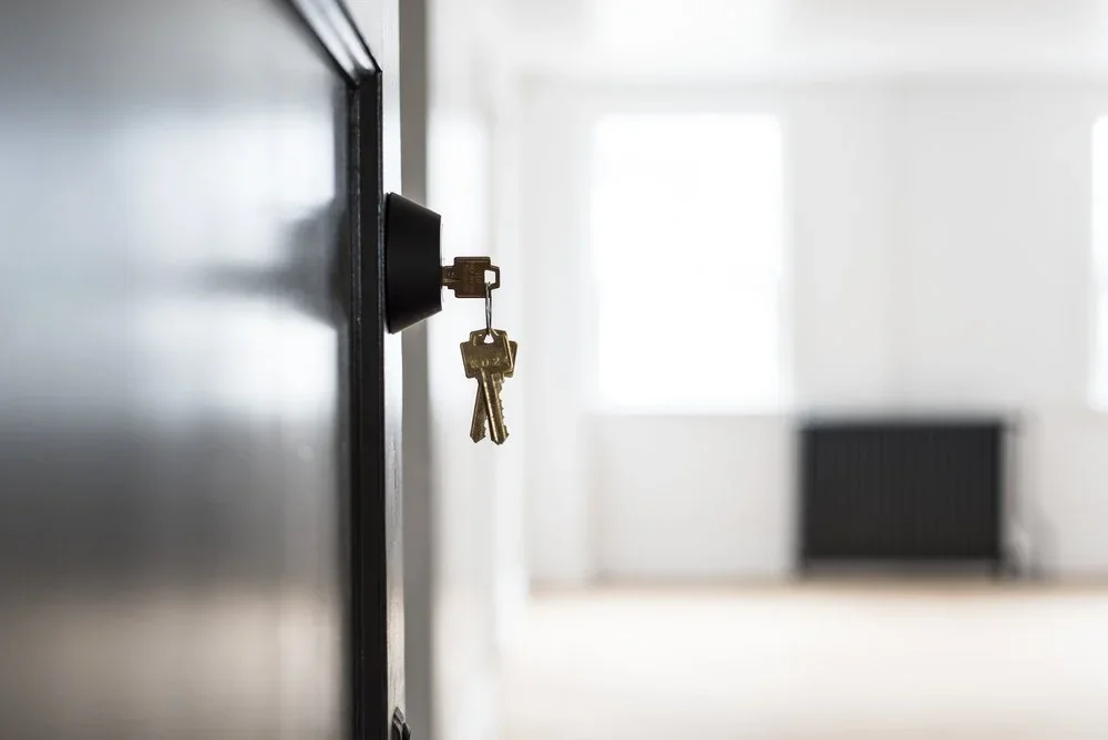 Keys in the door of a Kennedy floor home, the room beyond