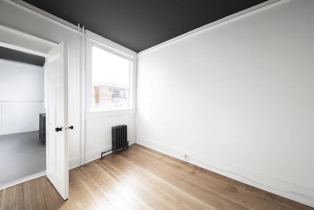 A room on the Rigby floor with a dark ceiling and a window onto the street