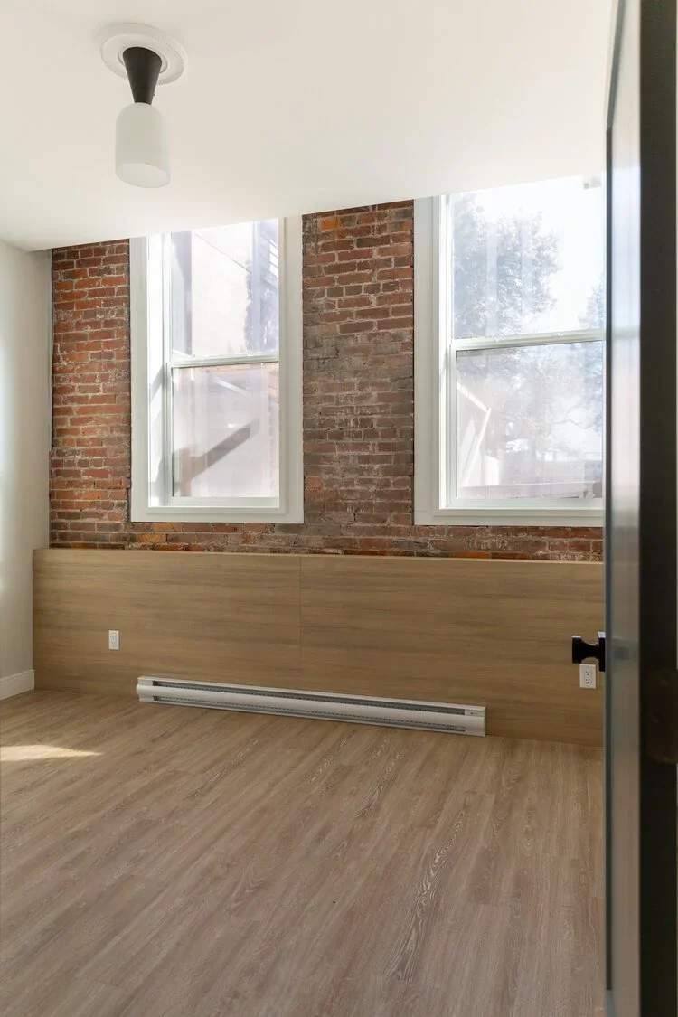 An upper room in a Meares Street townhouse, with exposed brick