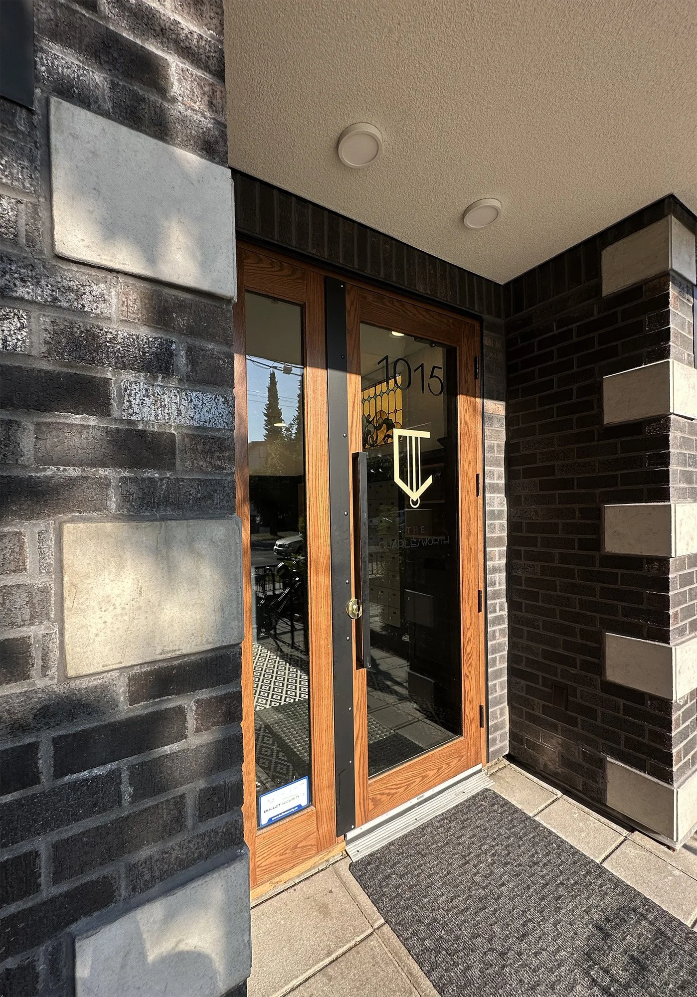 The entrance to The Charlesworth, numbered 1015, in black and grey brick