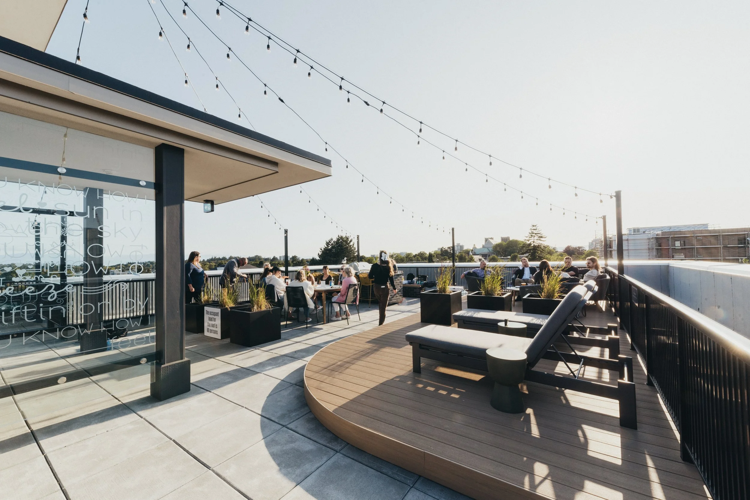 The rooftop terrace in the evening, strung with lights