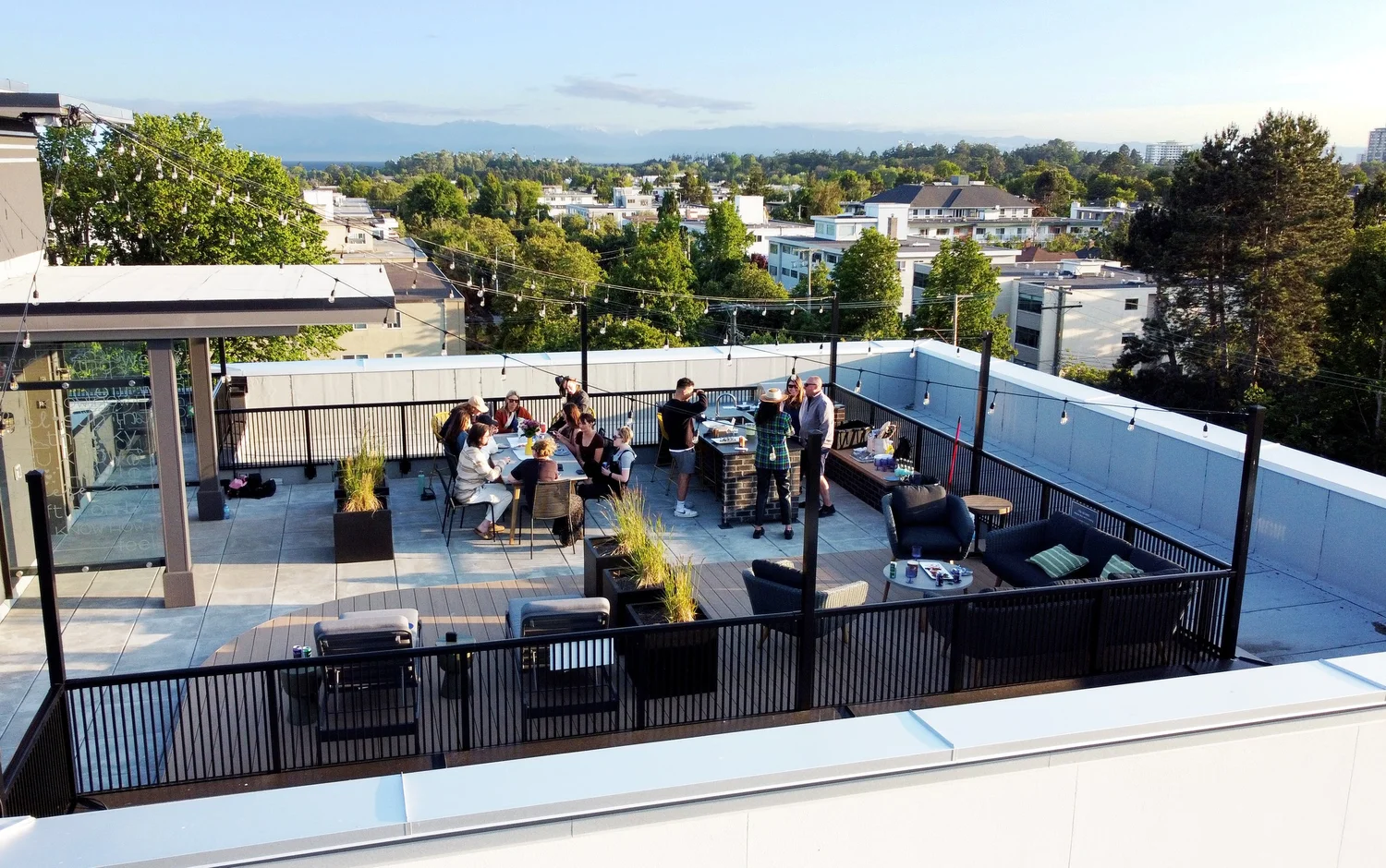 Residents on the rooftop terrace at The Charlesworth, looking over the city