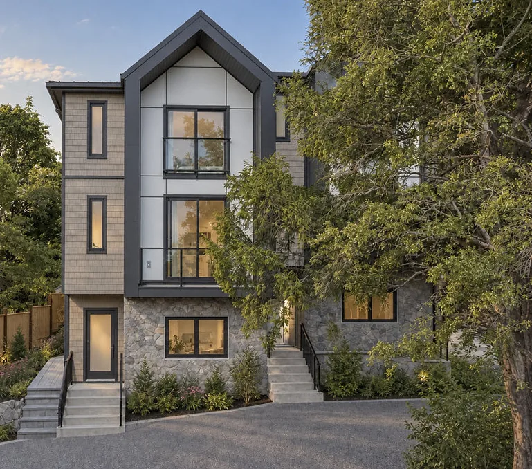 Edwin Oaks — the completed townhomes at dusk, shingle and stone under the garry oaks