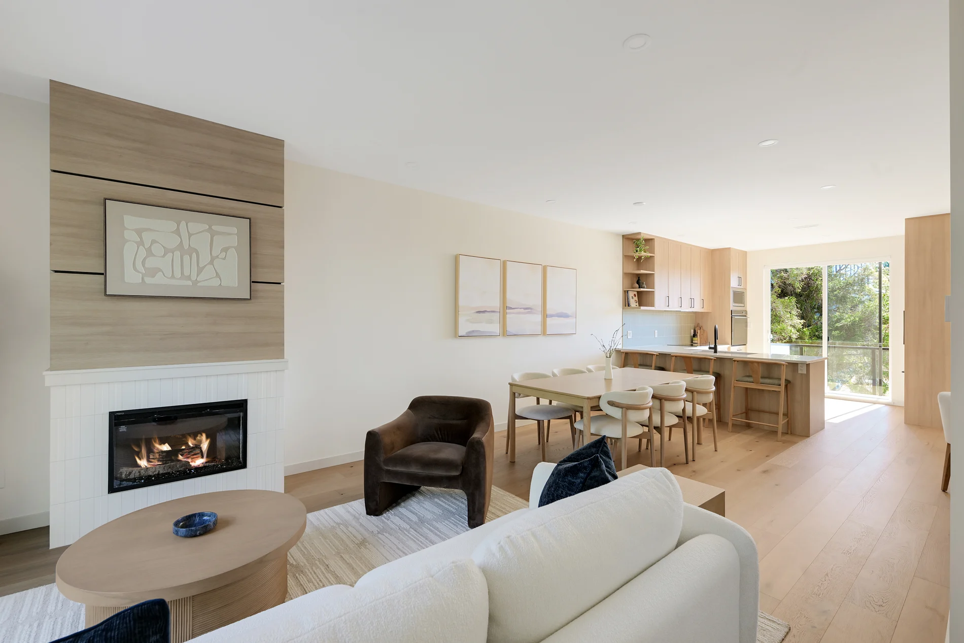The fireplace and seating, with the kitchen beyond