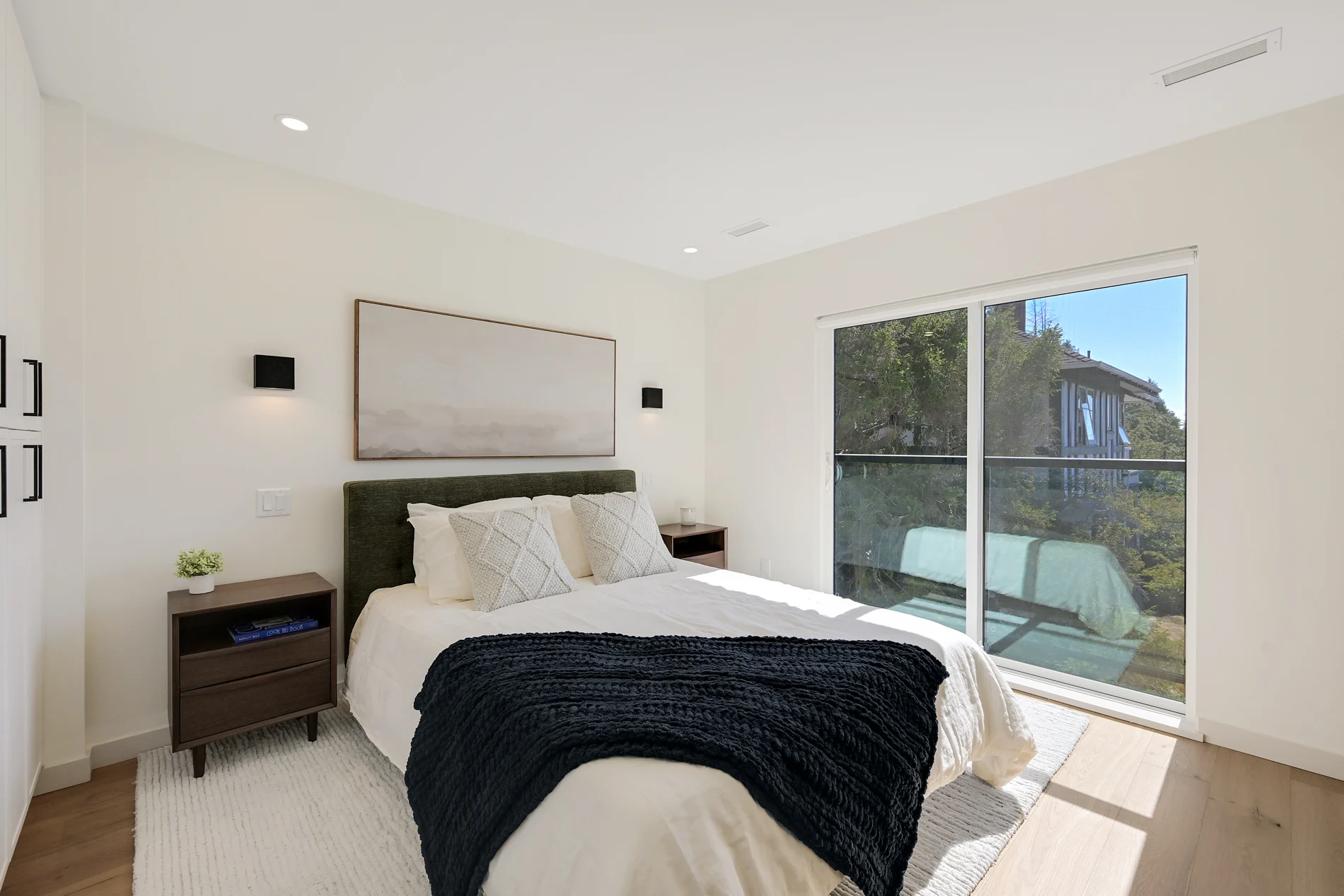 A bedroom with doors onto a balcony