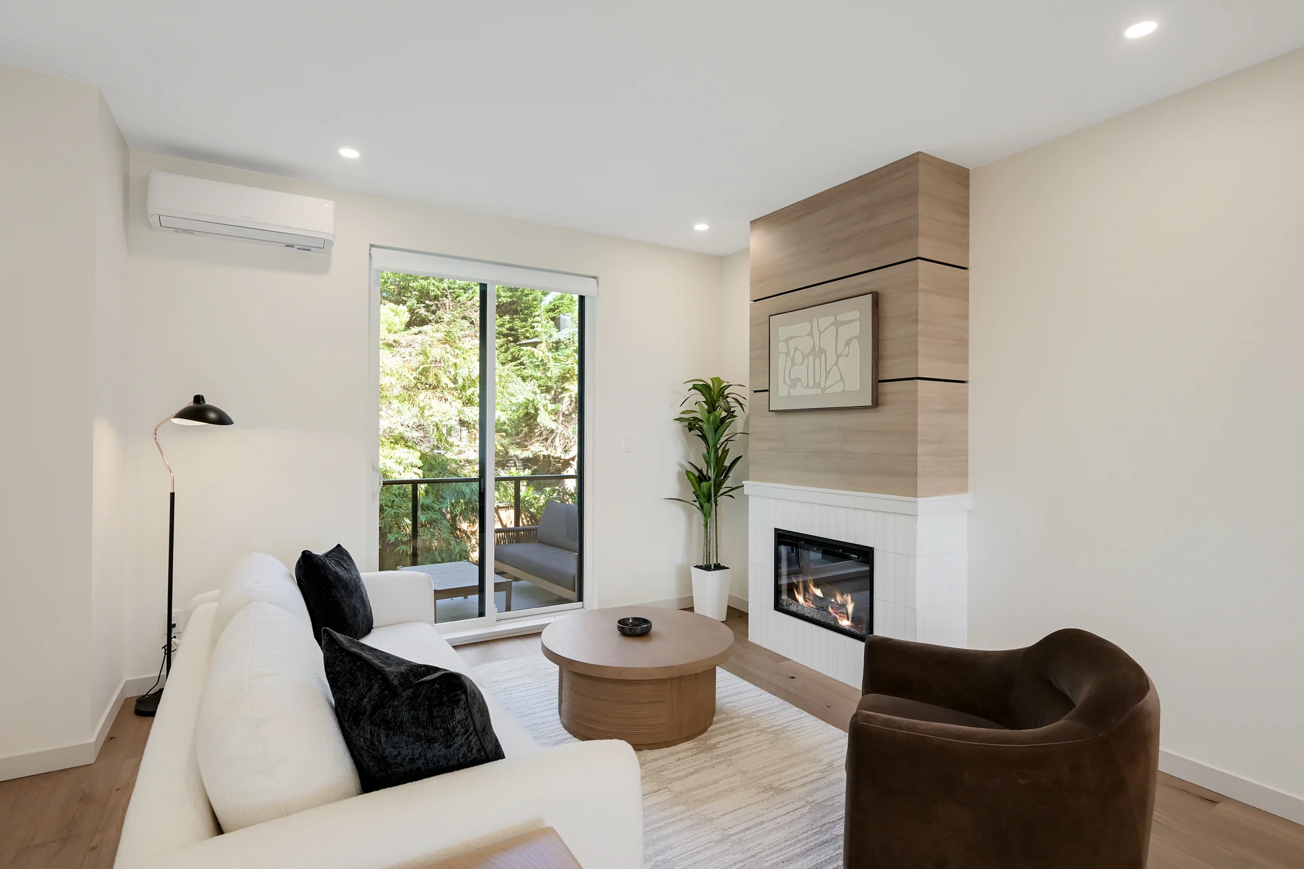 The fireplace lit, with doors onto the balcony