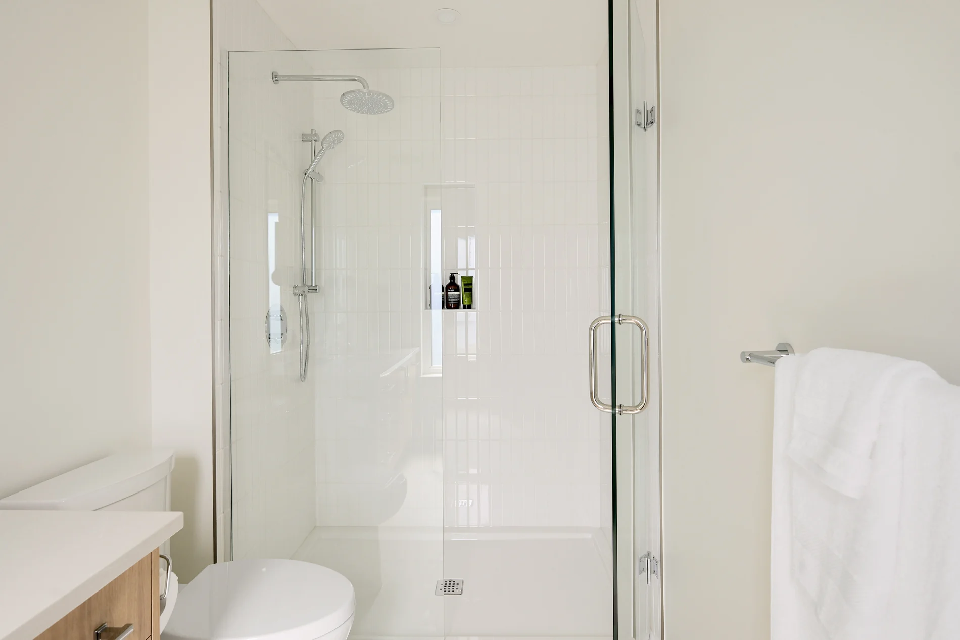 A walk-in shower behind glass