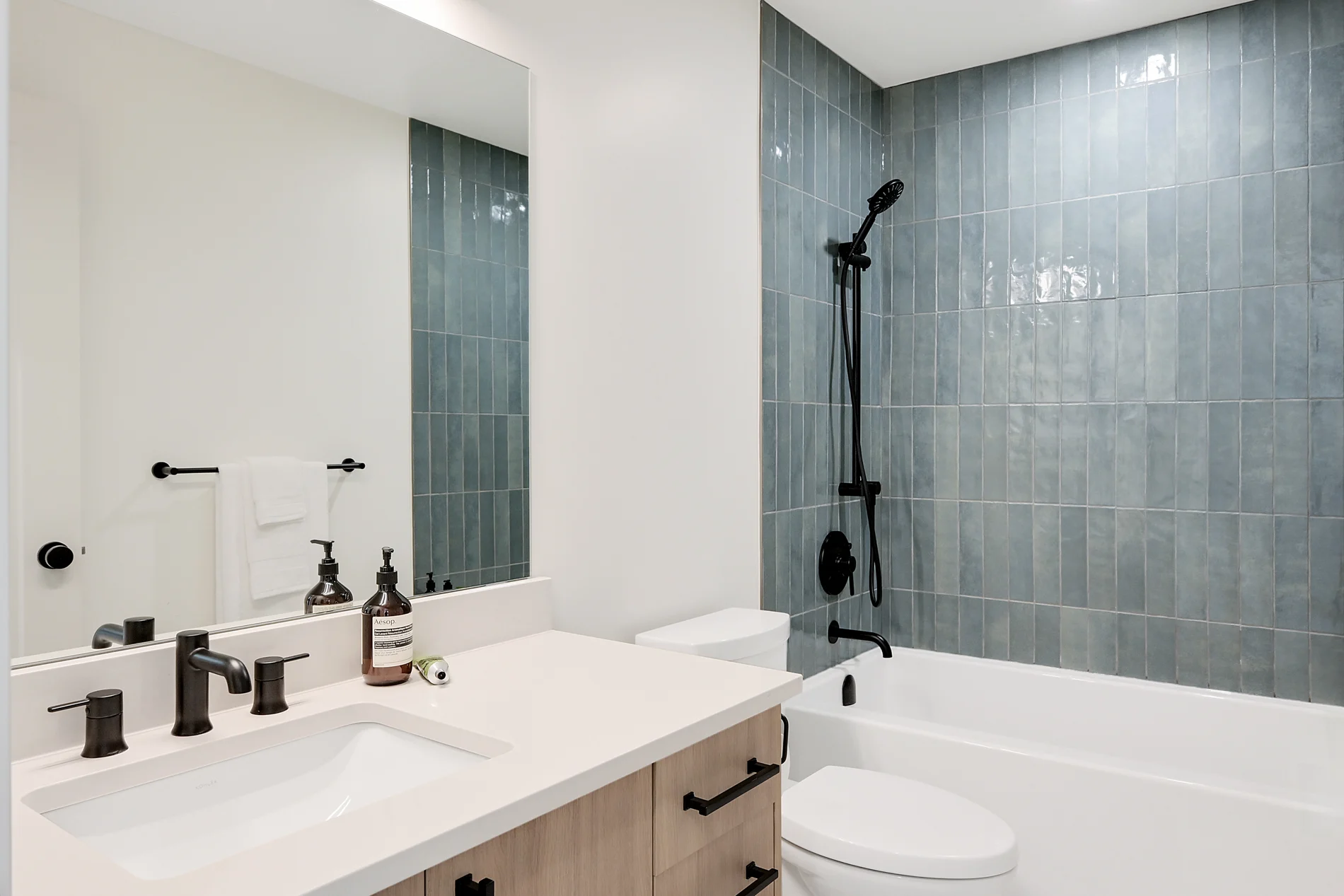 The vanity and mirror, with the tiled wall behind