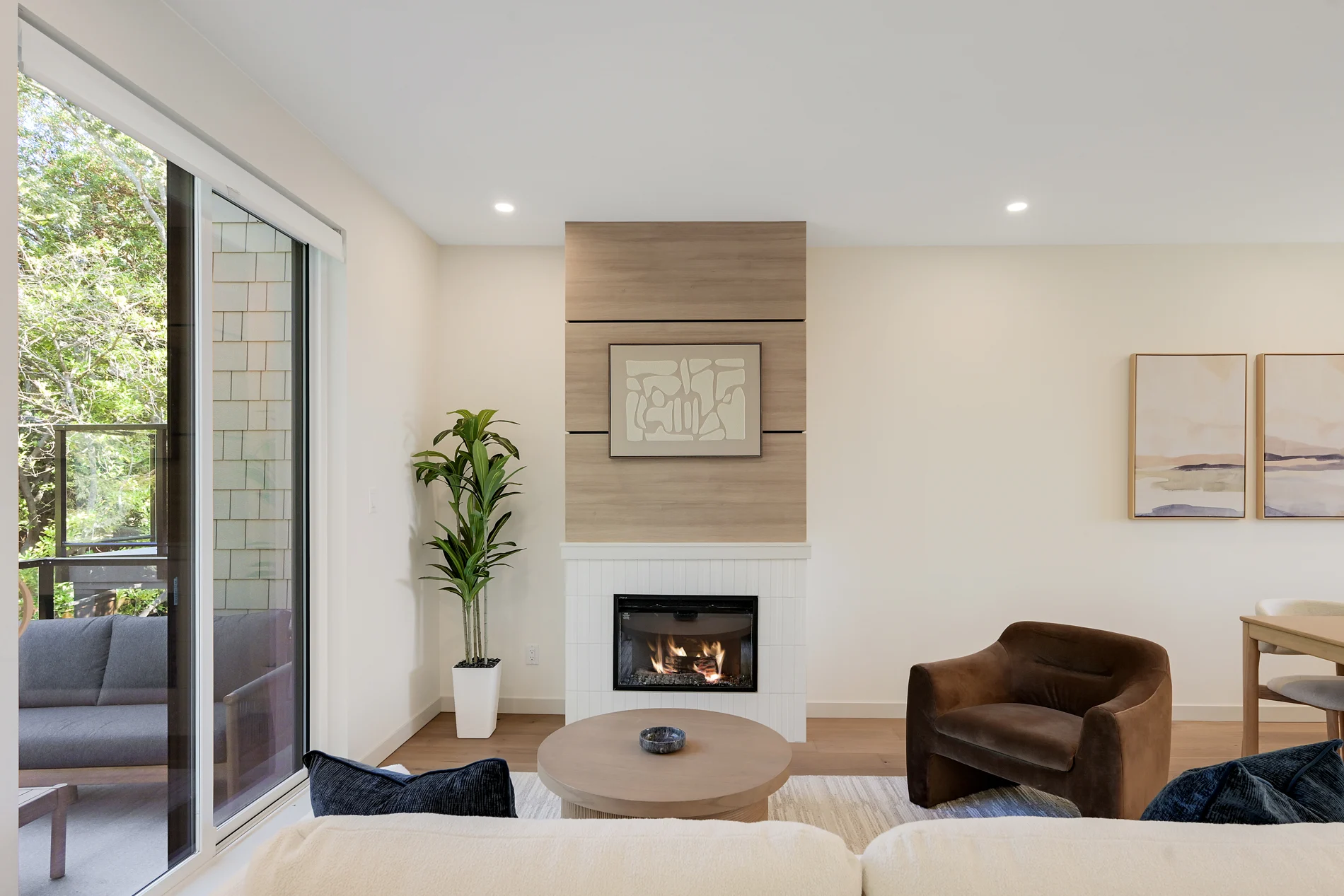 The display home’s living room, wide, with the balcony doors open