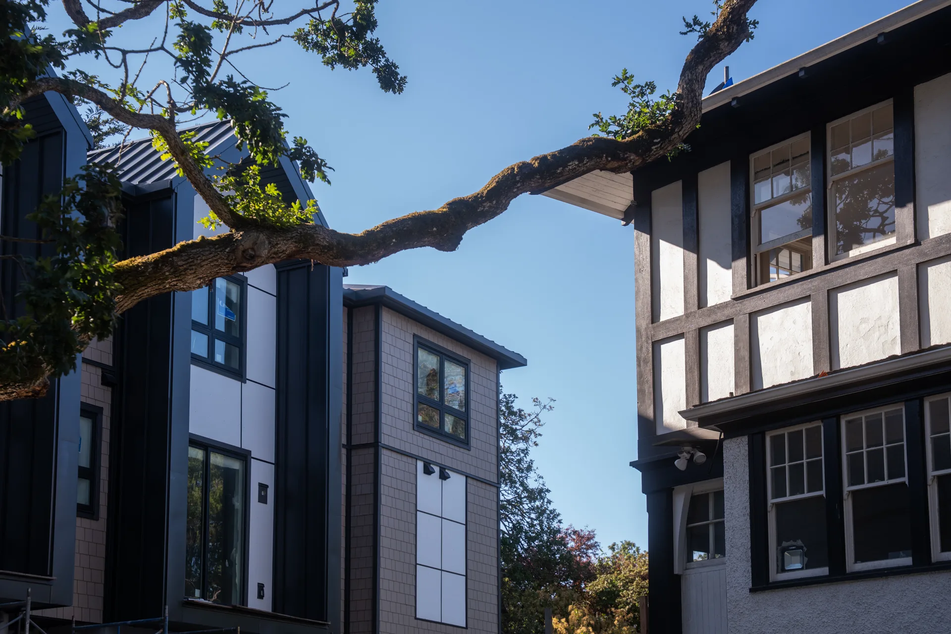 Edwin Oaks beside Tracksell Manor — the dark modern gable on the left, the manor’s half-timbering and stone on the right