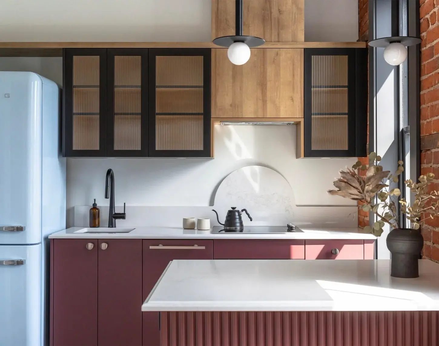 Kitchen in a GMC apartment, exposed brick behind