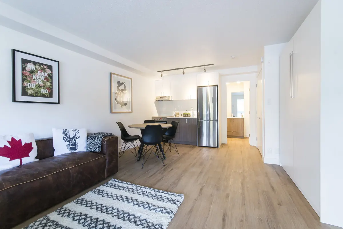 A living and dining room, looking through to the kitchen