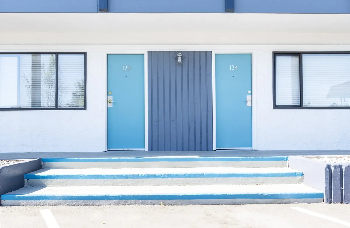 The blue doors of homes 123 and 124, off the courtyard