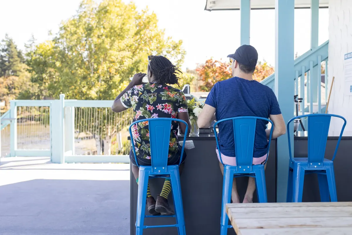 Two people on stools at the café counter