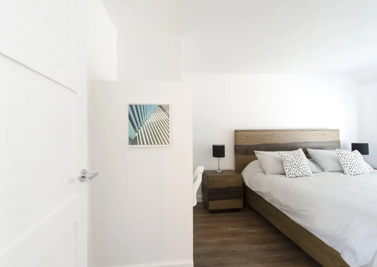 A bedroom with the door ajar