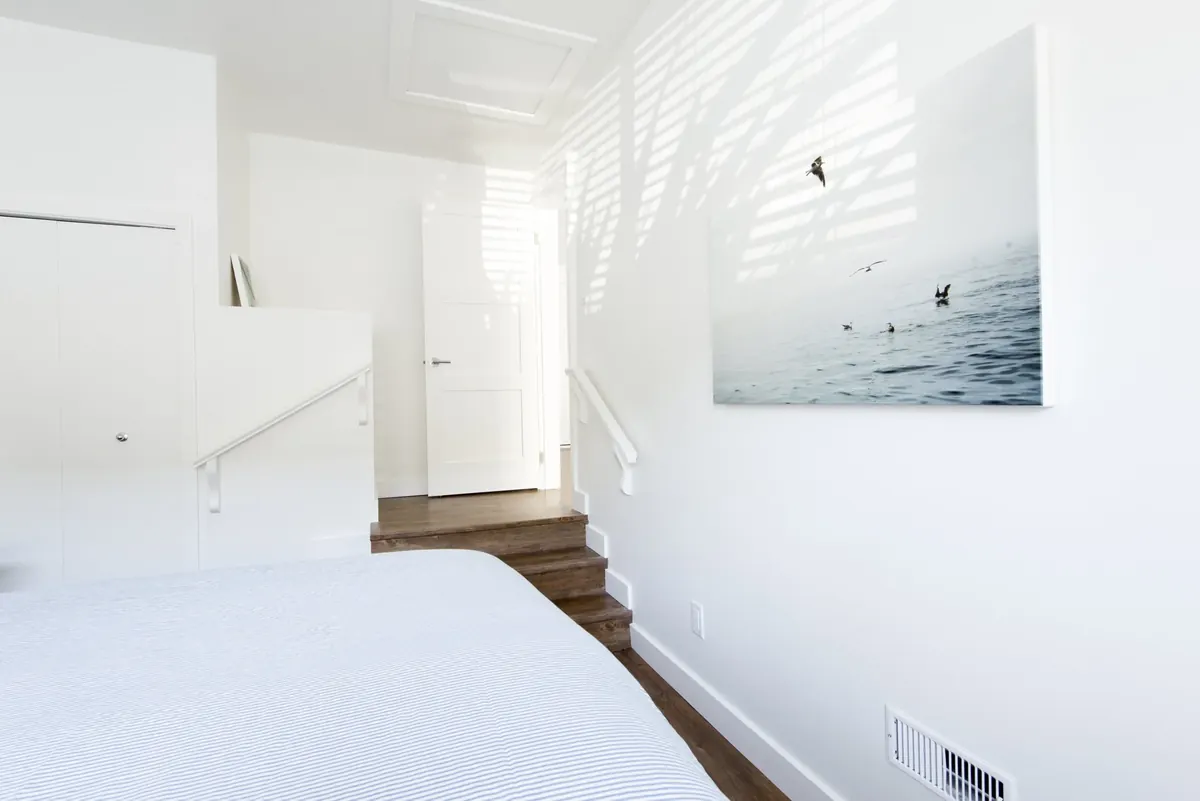 A bedroom under a sloped ceiling