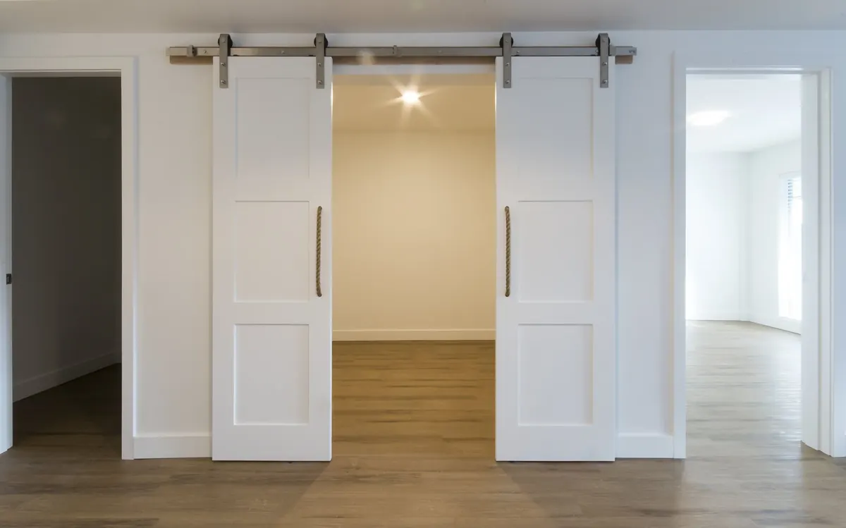 A barn door onto a bedroom