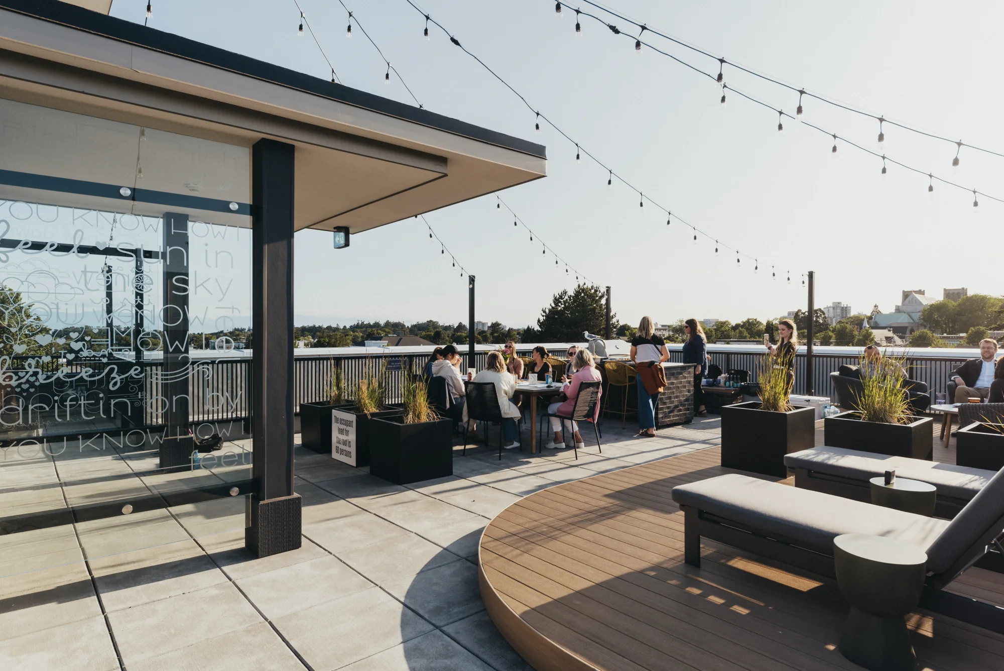 Residents on the rooftop terrace at The Charlesworth, looking over Victoria